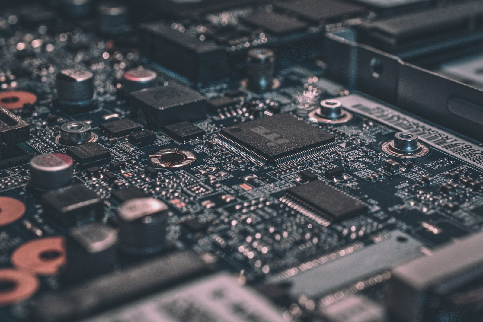 Close-up of a laptop motherboard — capacitors, BGA chips and traces